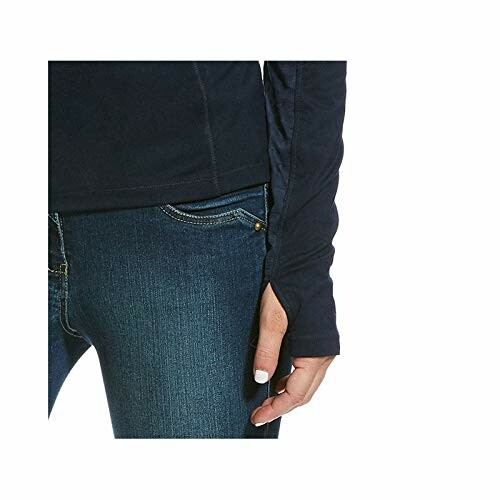 Close-up of denim jeans and a navy long-sleeve top with thumbhole.