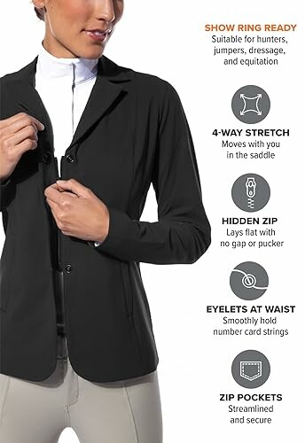 Person wearing a black equestrian jacket with features listed: 4-way stretch, hidden zip, eyelets at waist, zip pockets.