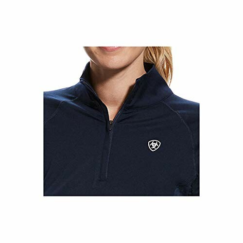 Woman wearing a navy pullover with a small logo on the chest