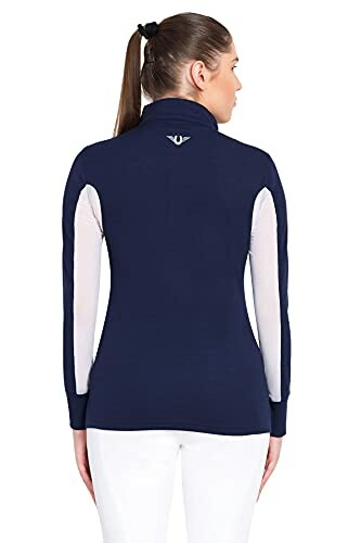 Woman wearing a navy sweater with white sleeves, viewed from the back.